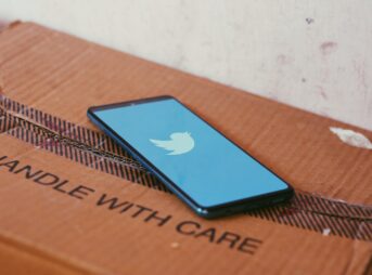 black ipad on brown wooden table