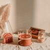 a table with a candle and a box of matches